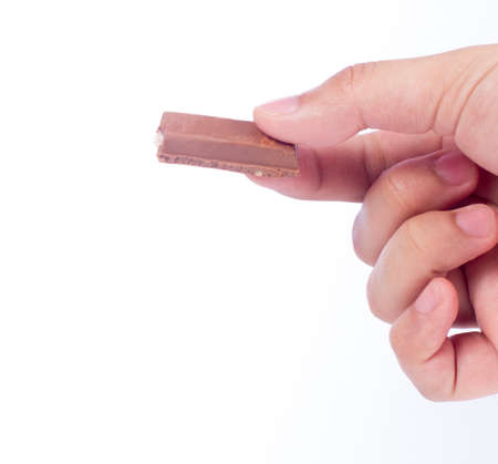 Hand hold three pieces of chocolate