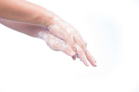 A man washes he hands with soap. Isolated on white