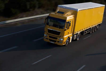 speed yellow truck with trailerの写真素材