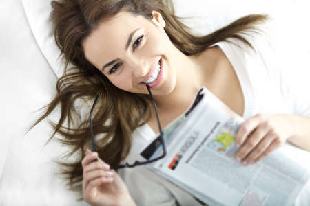 portrait of young woman with glass and smileの写真素材