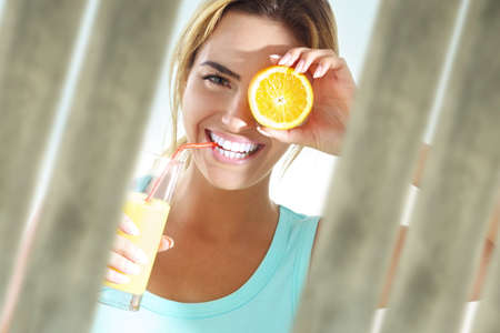 young woman with orange juiceの写真素材