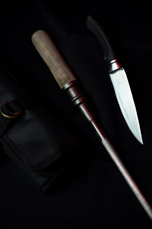 A knife and a knife on a black surface with caseの写真素材