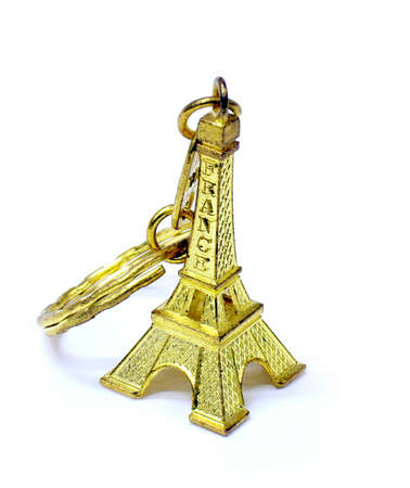 Small cute gold Eiffel tower key chain on white isolate backgroundの写真素材