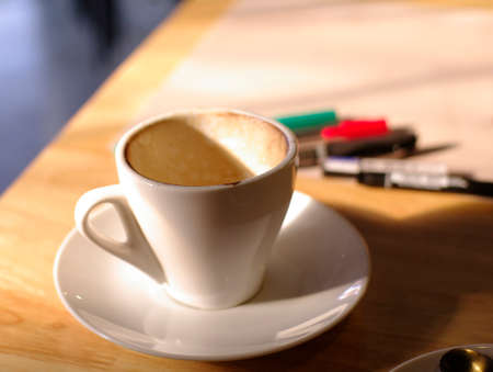 Empty coffee cup with working backgroundの写真素材