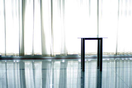 curtain and table in a white light の写真素材