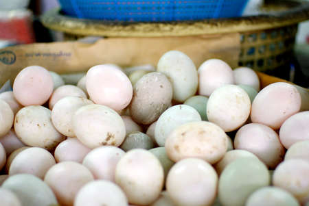dirty organic eggs pile in marketの写真素材