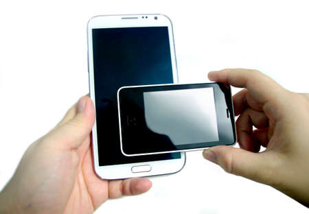 hand with smartphones double screensの写真素材