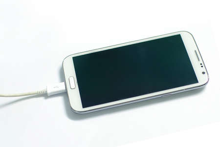 charging white mobile deviceの写真素材