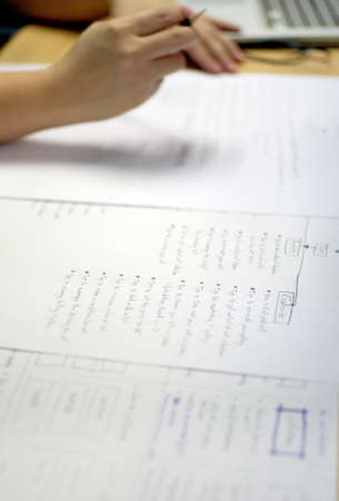 working writing a list on paper with hand and pencilの写真素材