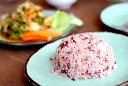 brown, red, purple organic cooked rice with Asian foodの写真素材
