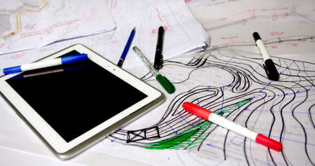 architect working space with papers, markers, pens and tabletの写真素材