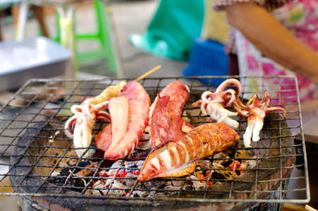 charcoal grilled squid on local marketの写真素材