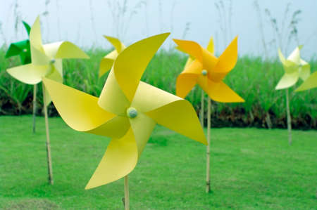 colourful windmill field in grass fieldの写真素材
