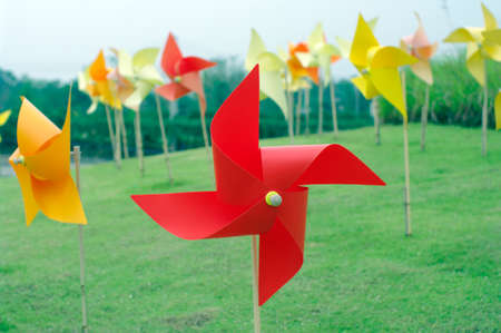 colourful windmill field in grass fieldの写真素材