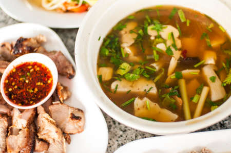 thai traditional spicy muchroom soup with pork bbqの写真素材