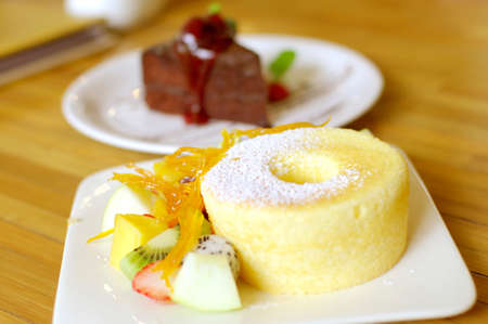 sponge cake with orange and tropical fruitsの写真素材