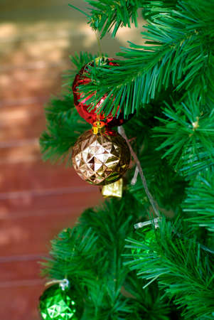 red and gold ornament on christmas pine treeの写真素材