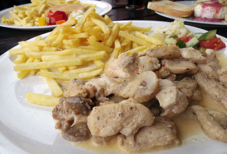 chicken steak with french fries with onionの写真素材