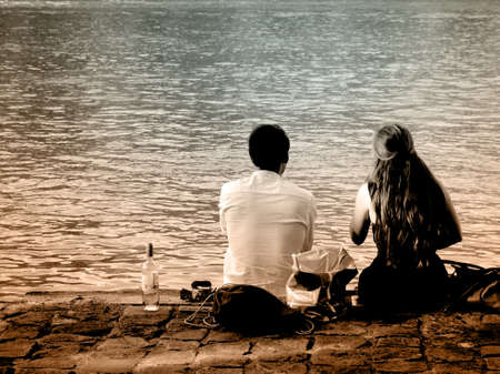 lover in paris, couple chilling next to the river, drinking wine togetherの写真素材