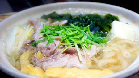 Japanese udon hot pot prok with vegetable and seaweedの写真素材