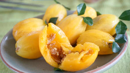 Fusion Thai food, sweet yellow marian plum fruit stuffed with pork meatの写真素材