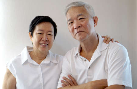 Happy Asian senior couple on white background love and hugの写真素材