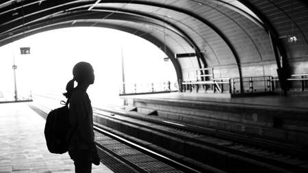 Silhouette for tourist girl backpacker waiting for train at the open station, travel abstractの写真素材