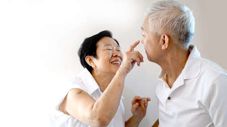 Happy Asian senior couple on white background love and hugの写真素材