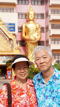 Asian seniors couple travel to temple wearing colourful clothesの写真素材