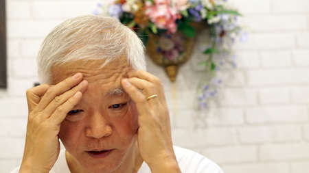 Asian man with life problem, unhappy face. Marriage problem wearing wedding ringの写真素材