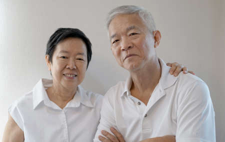 Happy Asian senior couple on white backgroundの写真素材