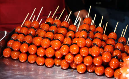 tomato glazed on stick in Taiwan night marketの写真素材