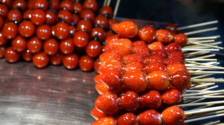 strawberry and tomato glazed on stick in Taiwan night marketの写真素材