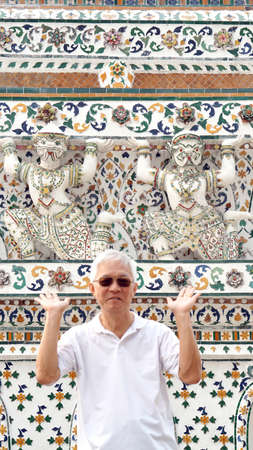 Asian senior man and monkey statue around Wat Arun, Temple of Dawn. Landmark of Bangkok, Thailandの写真素材