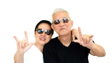Asian senior couple showing Iove hand gestureの写真素材