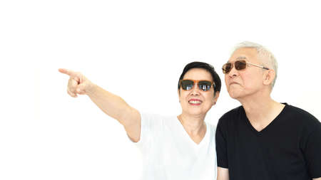 Asian senior couple pointing white isolate backgroundの写真素材