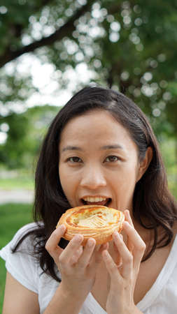 Asian woman mature adult eating bread carbohydrates