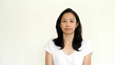 Casual asian girl on white background smiling face with relax tee shirtの写真素材