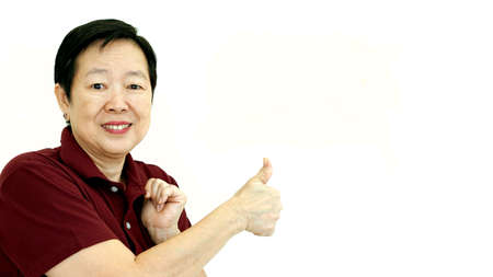 asian senior woman thumb up smiling on white isolate background with copy spaceの写真素材