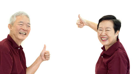 Asian senior couple thumb up with white isolate backgroundの写真素材