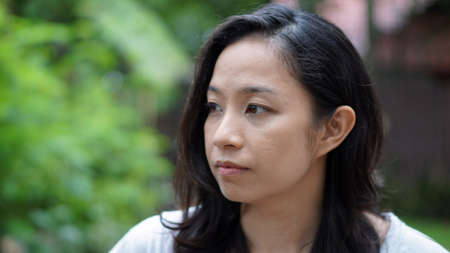 Mixed race asian girl in nature, naturally look awayの写真素材