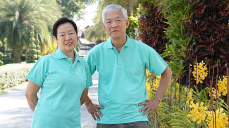 asian senior couple smiling togher in green natureの写真素材