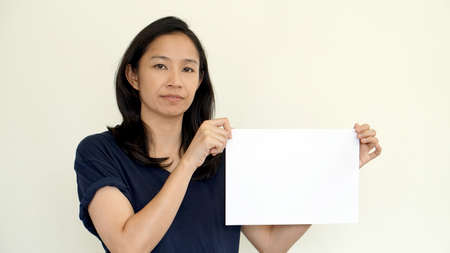 South East Asian girl holding while sign for copy space