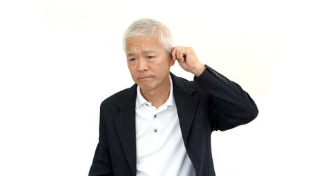 asian senior business man wearing suit and do upset gestureの写真素材