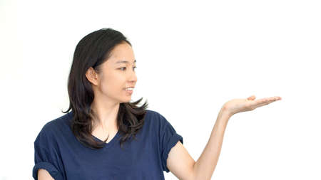 South East Asian girl doing presentation hand gesture with  copy spaceの写真素材