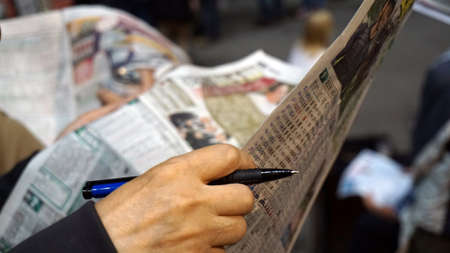 Horse or dog racing gambling hand check points and information from newspaper. Abstract gamble