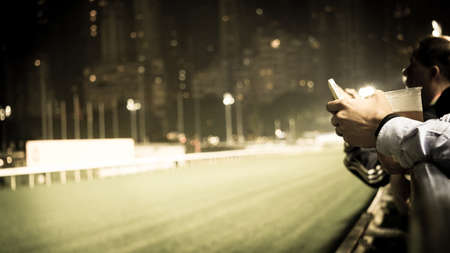 Crowd at horse race course edge cheering, taking photo and prepare for game gabling