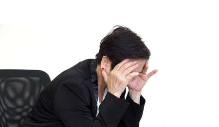 Asian senior woman stress out at office, business economy situation conceptの写真素材