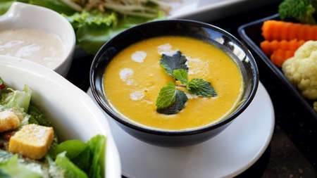Creamy pumpkin soup serve with other organic foodの写真素材