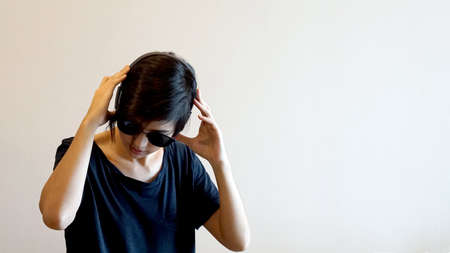 Asian cool hipster girl wearing sunglasses and headphone, urban lifestyle conceptの写真素材